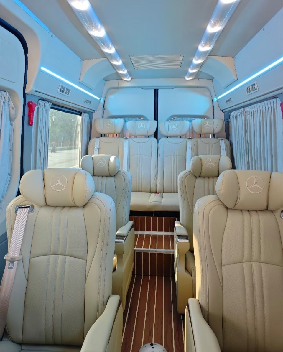 Beige Sprinter high-roof cabin with blue lighting and wood-look flooring