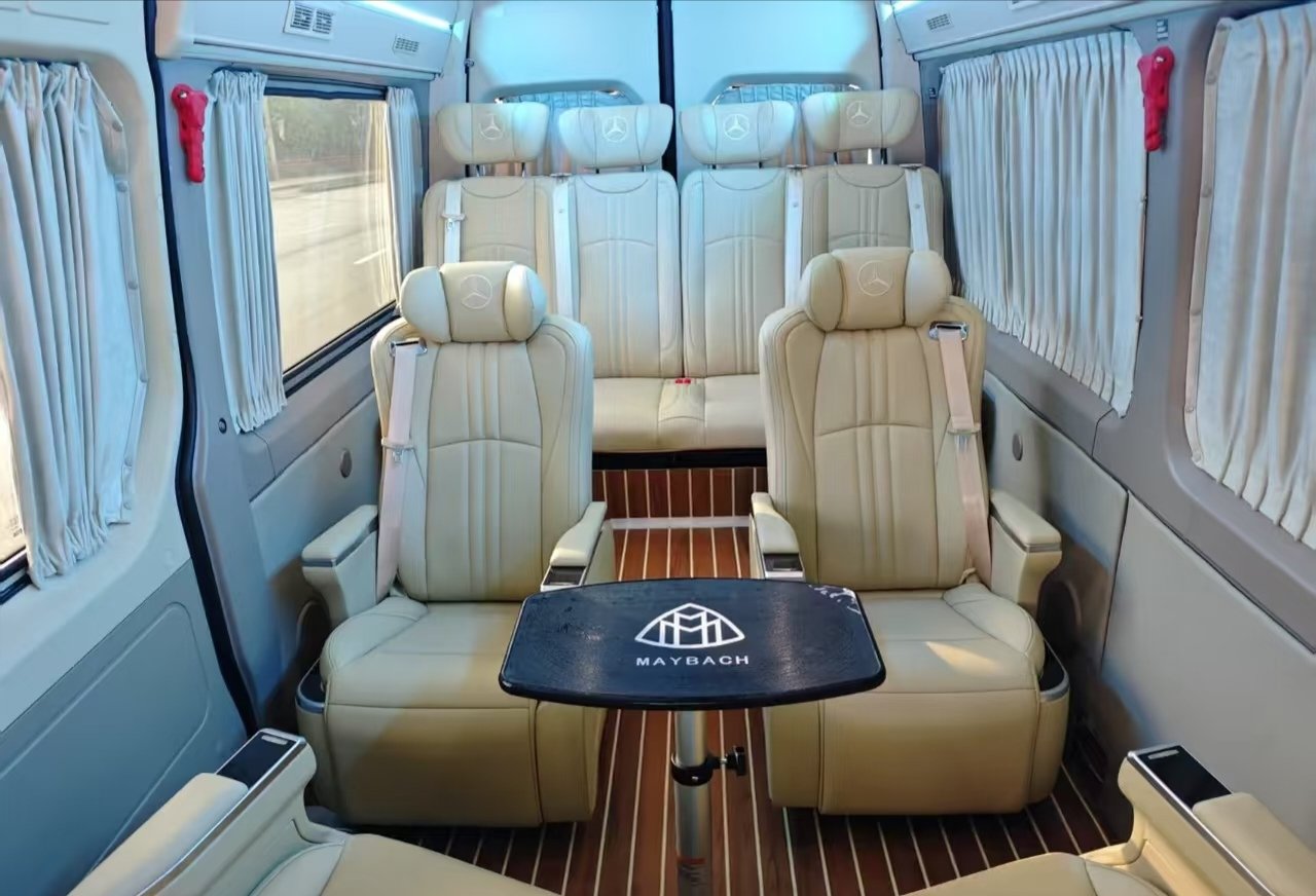 Beige Mercedes-Benz Sprinter lounge seats around a central table