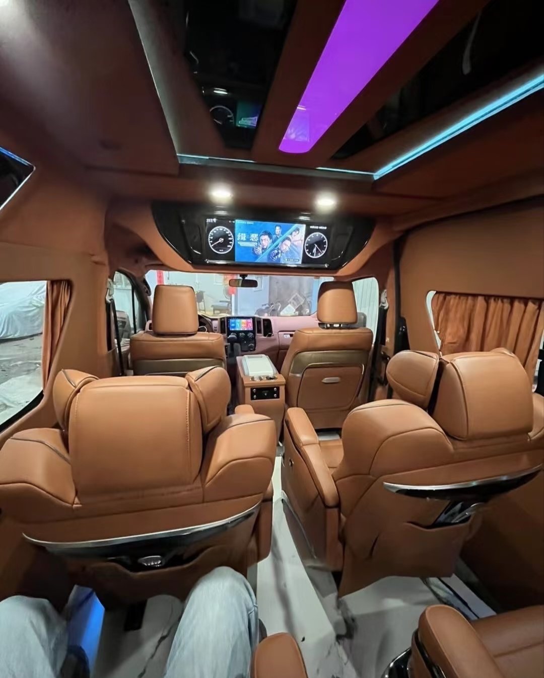 Brown cabin trim with blue and purple accent lighting and passenger display