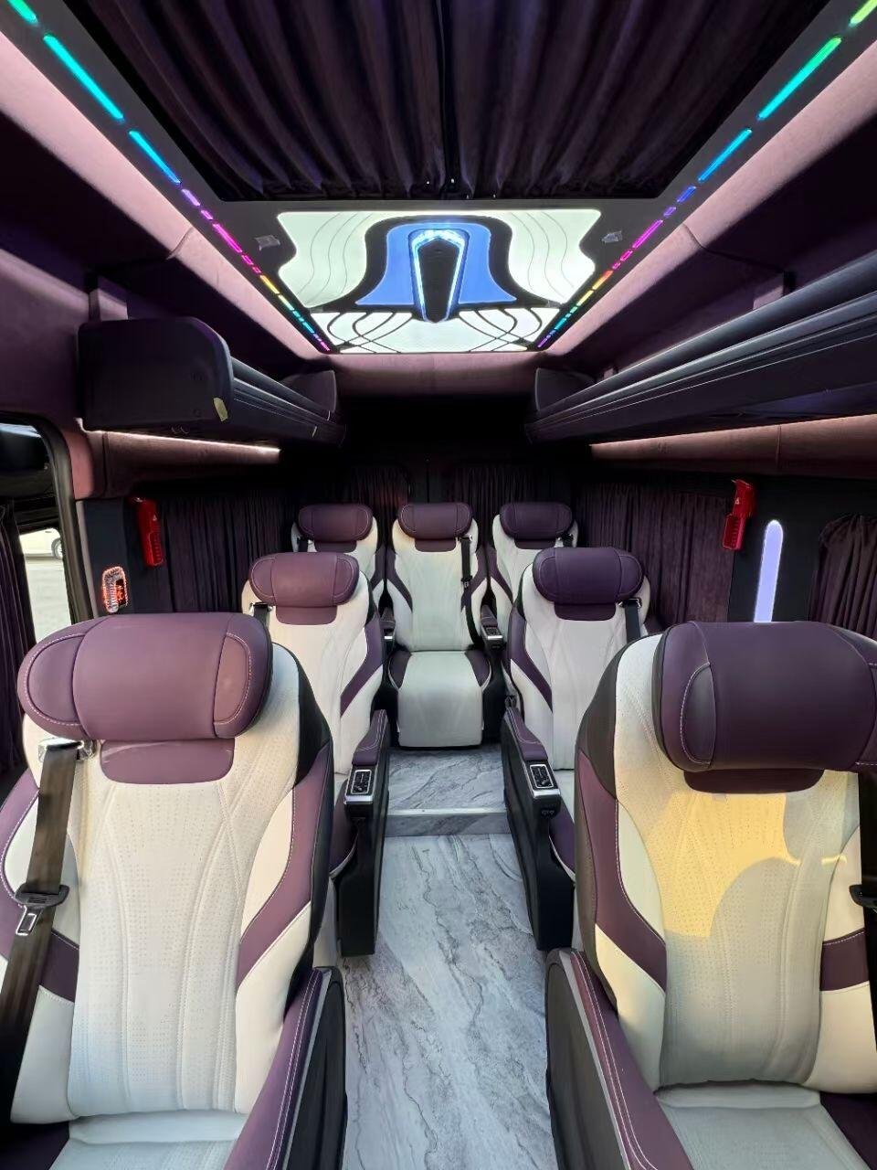 Transit cabin with individual chairs, central aisle and decorative lighting