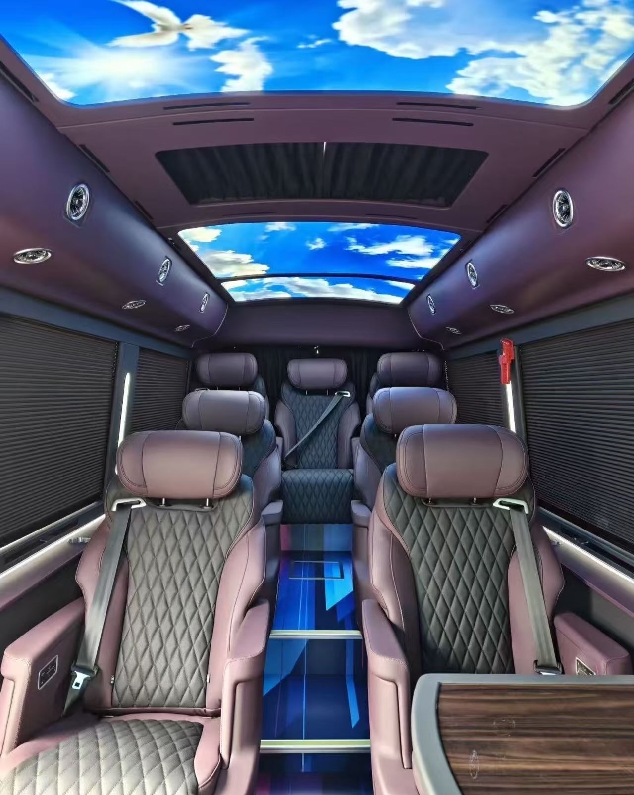 Ford Transit quilted passenger seats beneath blue-sky ceiling panels