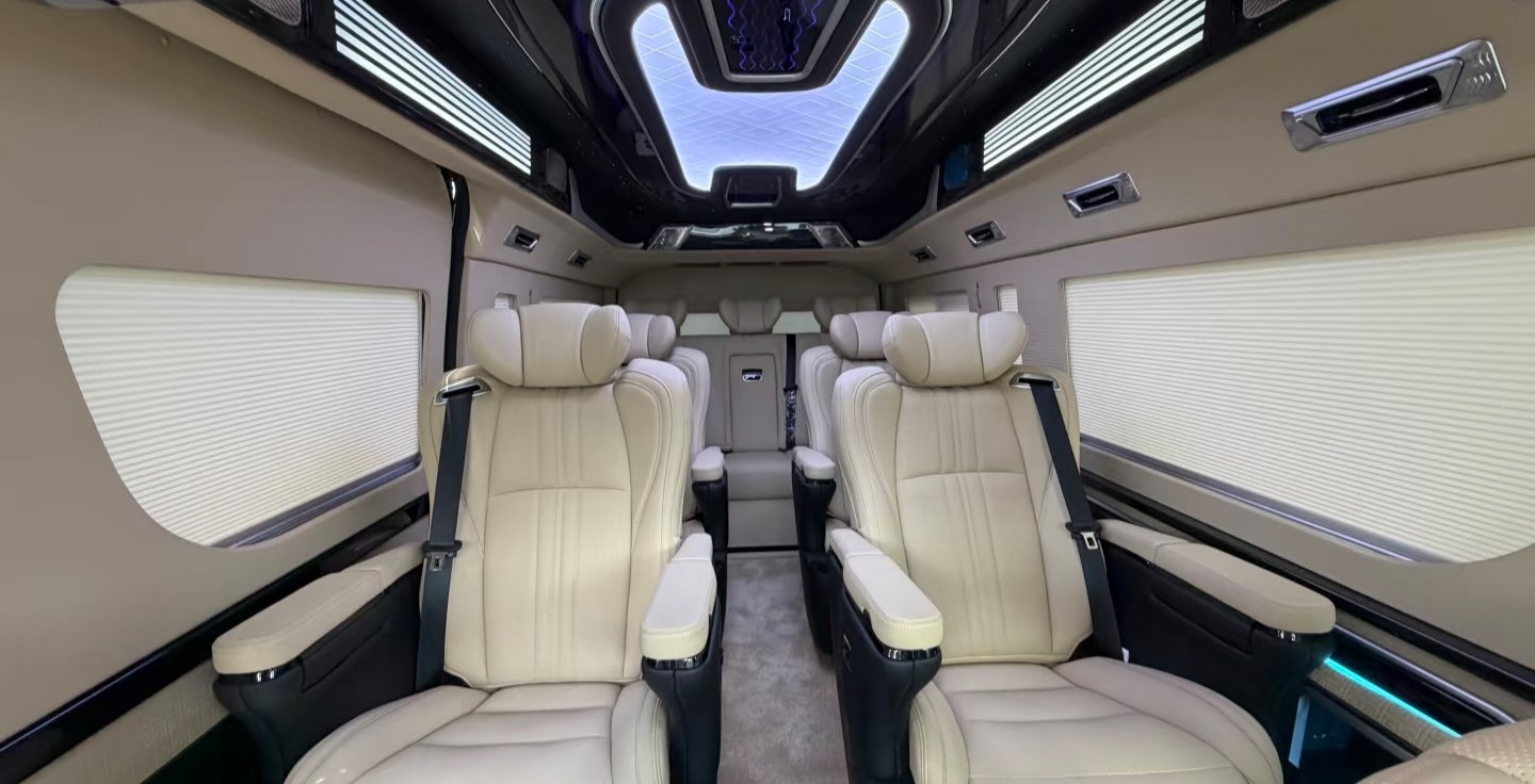Beige individual passenger seats and rear bench in a Toyota Hiace interior reference